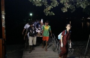 Rescue workers bring a 20-year-old tourist who was struck by a boat turbine to a hospital on Koh Samui