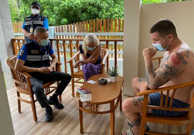 An immigration police officer interrogates one of two German drugs fugitives arrested on Tuesday morning.