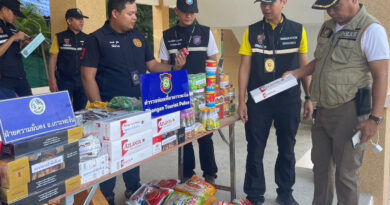 Police seize contraband goods at a grocery run by a Myanmar woman on Koh Phangan in Surat Thani on Wednesday.