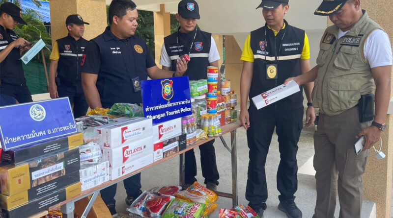 Police seize contraband goods at a grocery run by a Myanmar woman on Koh Phangan in Surat Thani on Wednesday.